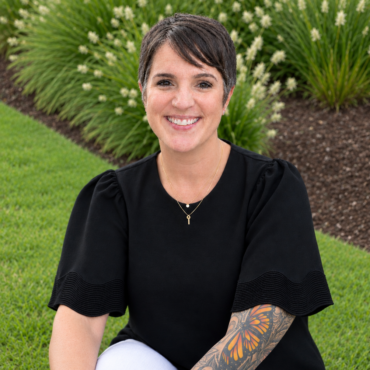 Smiling Garden Portrait with Tattooed Arm